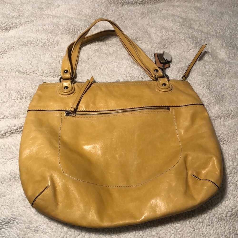 Butter yellow Coach shoulder bag.